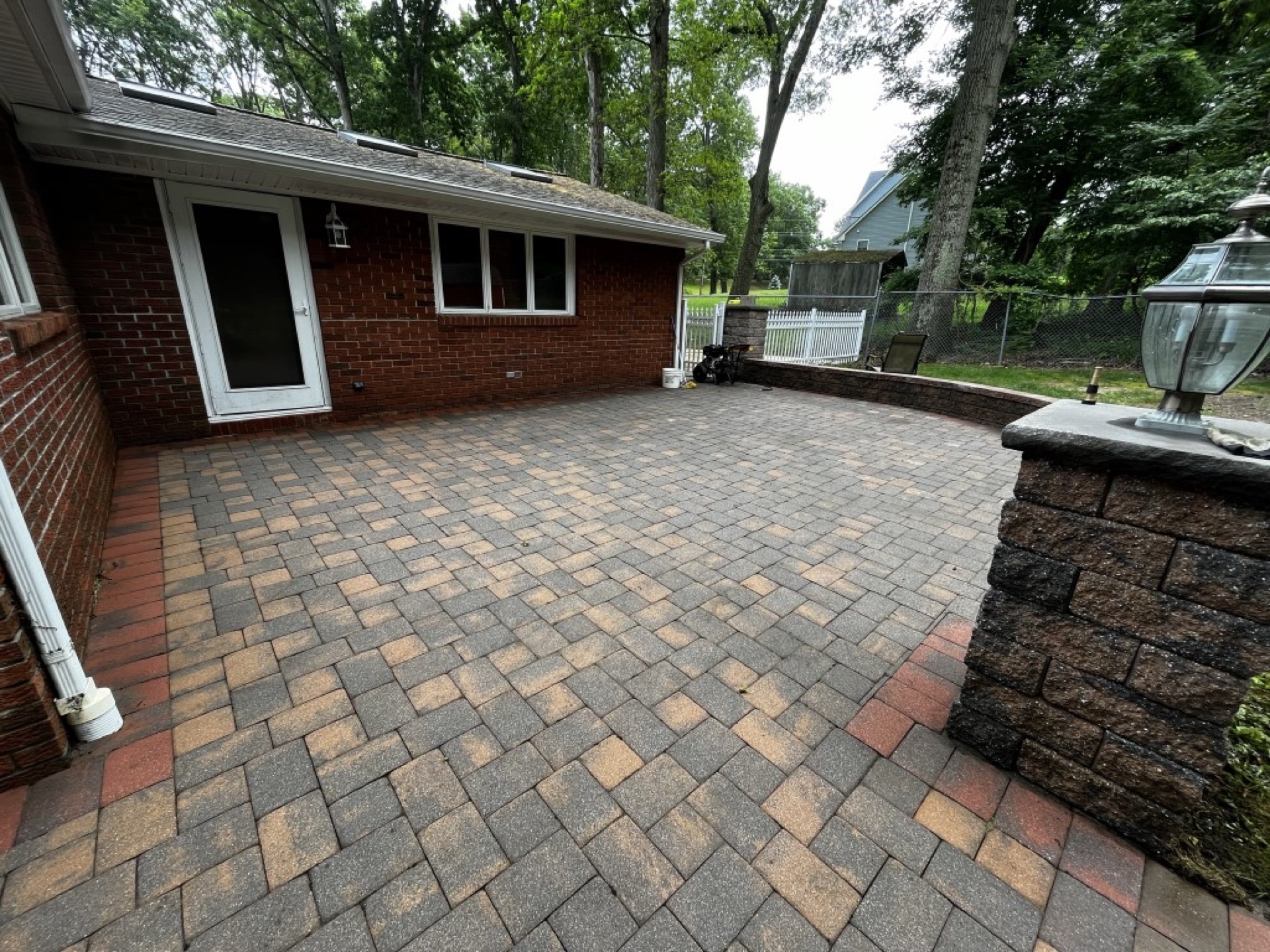 Power washing a concrete driveway to remove stains and grime